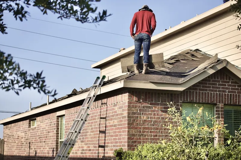 Professional roofer working on a residential roof in Mews at Wickford Commons